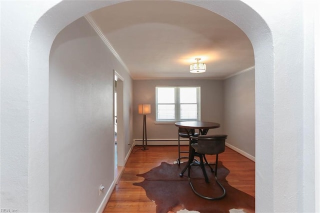 miscellaneous room with hardwood / wood-style flooring, crown molding, and baseboard heating