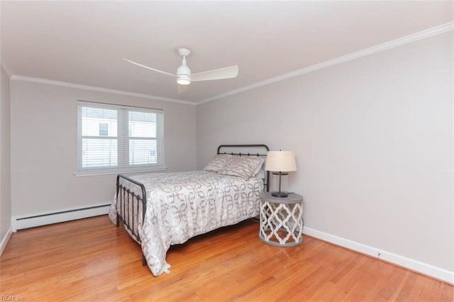 bedroom featuring hardwood / wood-style flooring, crown molding, ceiling fan, and a baseboard heating unit