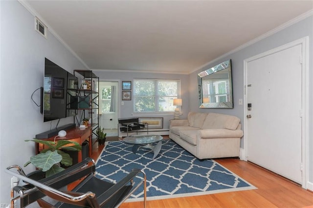 living room with ornamental molding and hardwood / wood-style flooring