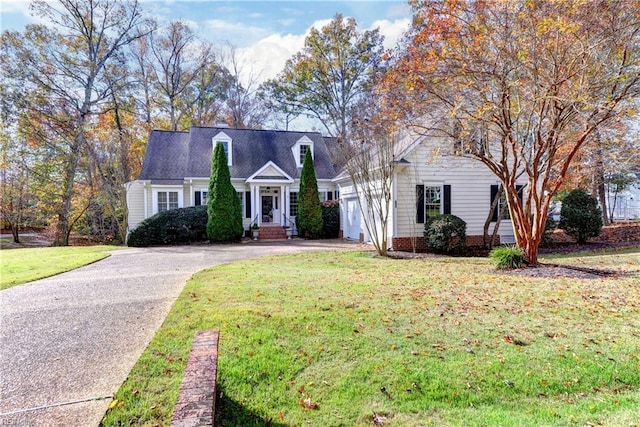 cape cod-style house featuring a front lawn