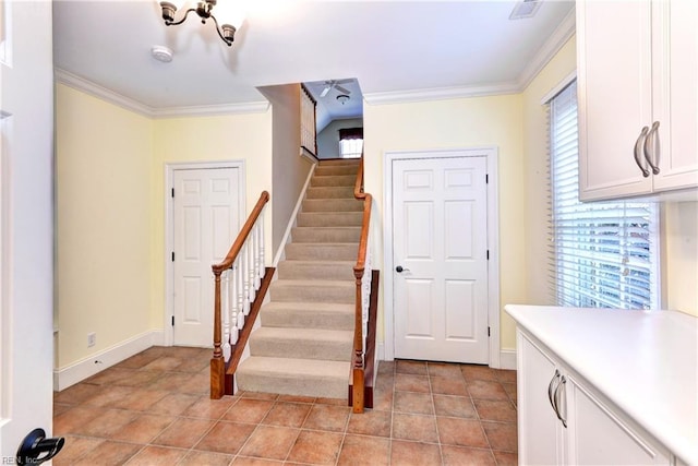 staircase featuring tile patterned floors and ornamental molding