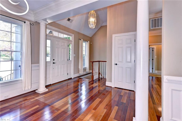 entryway with decorative columns, crown molding, plenty of natural light, and hardwood / wood-style floors