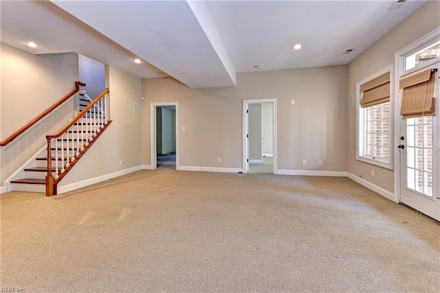 unfurnished living room with light colored carpet