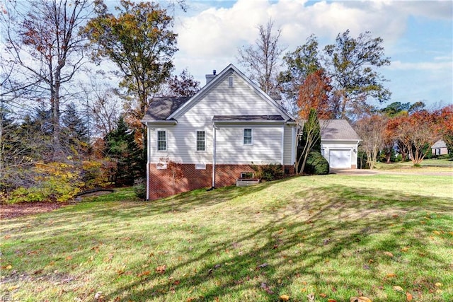 view of side of home featuring a lawn and a garage