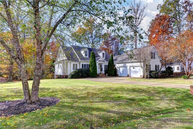 cape cod home featuring a garage and a front yard