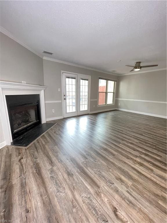 unfurnished living room with hardwood / wood-style floors, ceiling fan, ornamental molding, and a textured ceiling