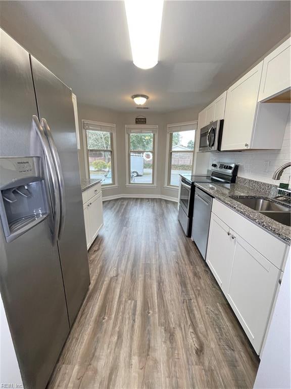 kitchen featuring white cabinets, appliances with stainless steel finishes, and sink