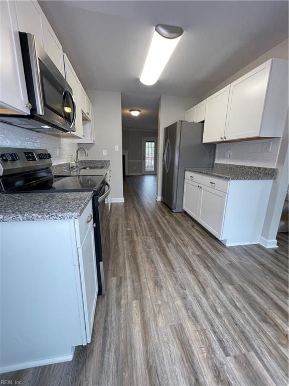 kitchen featuring white cabinets, sink, stainless steel appliances, and hardwood / wood-style flooring