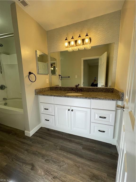 bathroom with vanity, shower / bathtub combination, and wood-type flooring