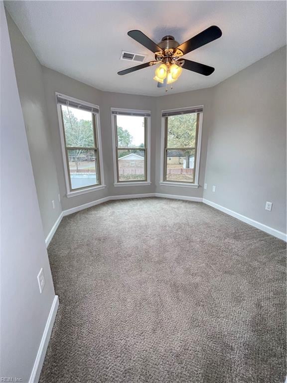 carpeted empty room featuring ceiling fan