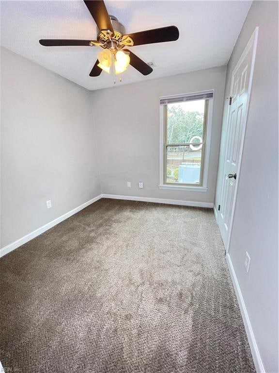 spare room with carpet floors and ceiling fan