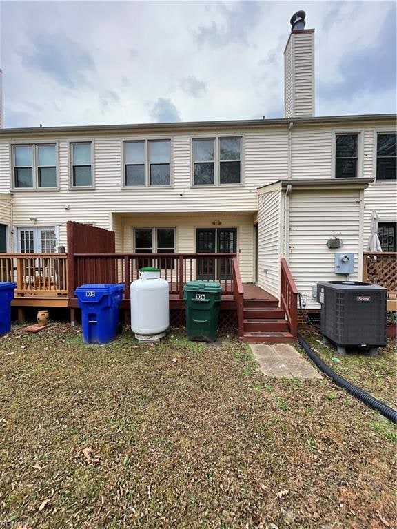 rear view of property with central AC unit and a deck