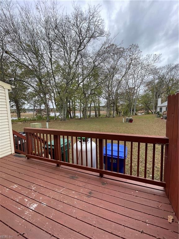 wooden deck featuring a yard