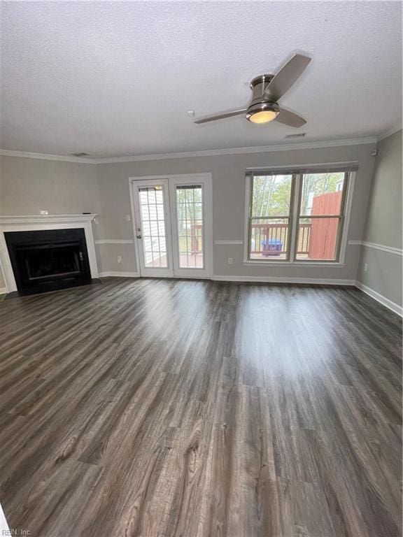 unfurnished living room featuring a textured ceiling, crown molding, and dark wood-type flooring