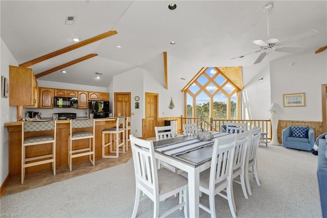 dining space featuring beamed ceiling, ceiling fan, light carpet, and high vaulted ceiling