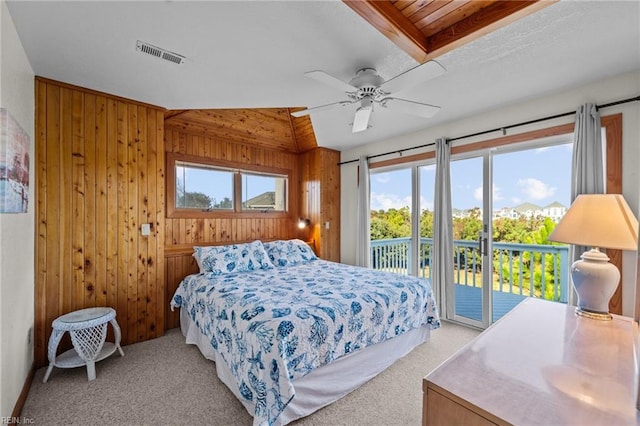 bedroom featuring multiple windows, ceiling fan, lofted ceiling, and access to exterior