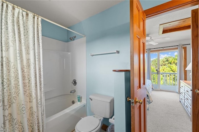 bathroom with shower / bath combo, toilet, and ceiling fan