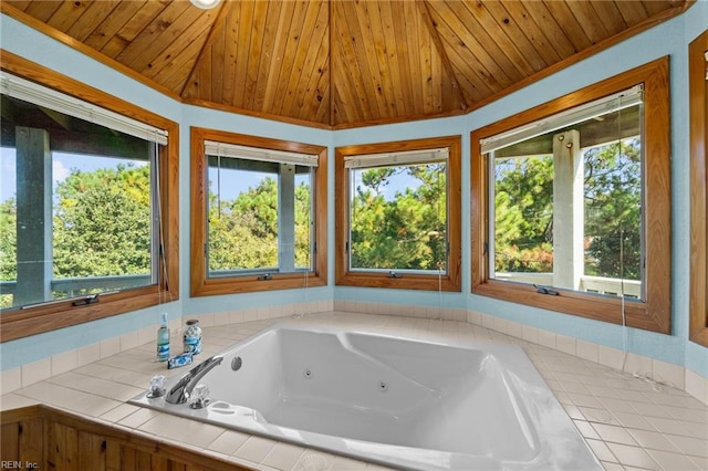 bathroom featuring a relaxing tiled tub, crown molding, and wood ceiling