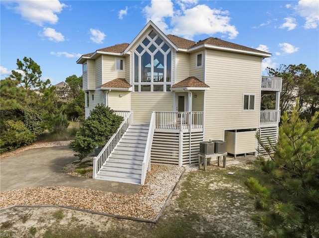 rear view of property with cooling unit