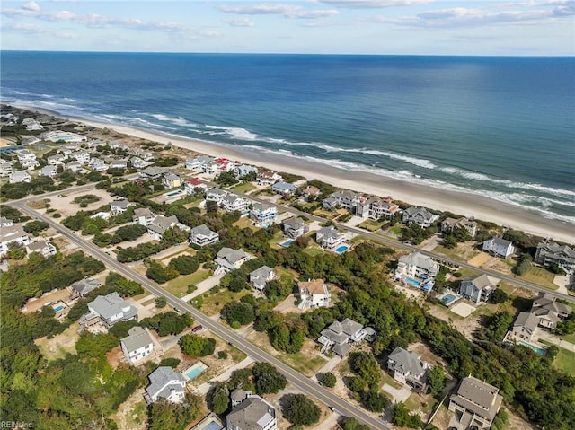 drone / aerial view featuring a beach view and a water view