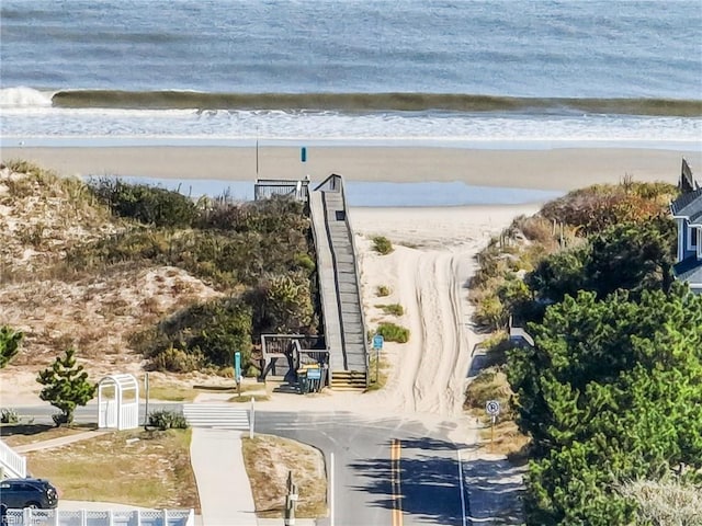 aerial view with a water view and a beach view