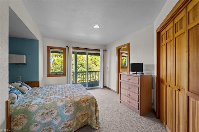 carpeted bedroom featuring access to exterior and a closet