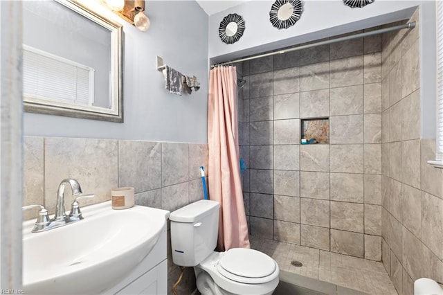 bathroom featuring toilet, tile walls, curtained shower, and sink