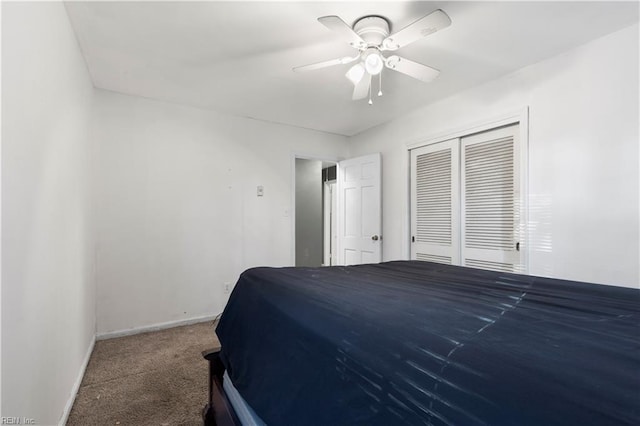 carpeted bedroom featuring ceiling fan and a closet