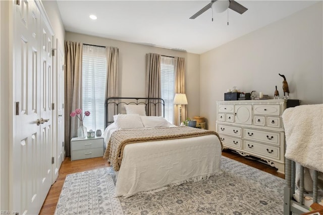 bedroom with ceiling fan, a closet, and light hardwood / wood-style flooring