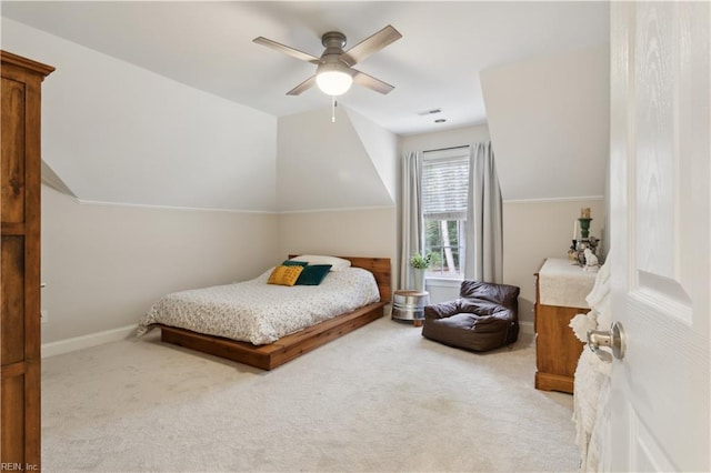 carpeted bedroom with ceiling fan and vaulted ceiling