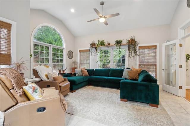 living room featuring light tile patterned floors, ceiling fan, and lofted ceiling