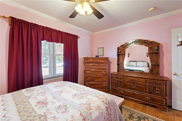 bedroom featuring ceiling fan, crown molding, and hardwood / wood-style flooring