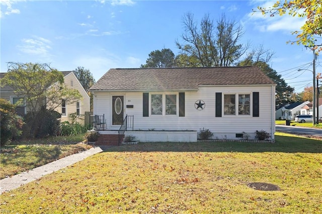 bungalow-style house featuring a front lawn