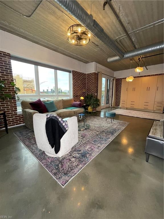 living room featuring a fireplace and brick wall