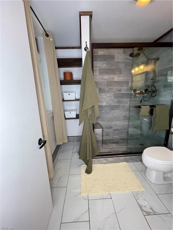 bathroom with toilet and walk in shower