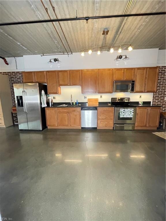 kitchen featuring sink, decorative light fixtures, and appliances with stainless steel finishes