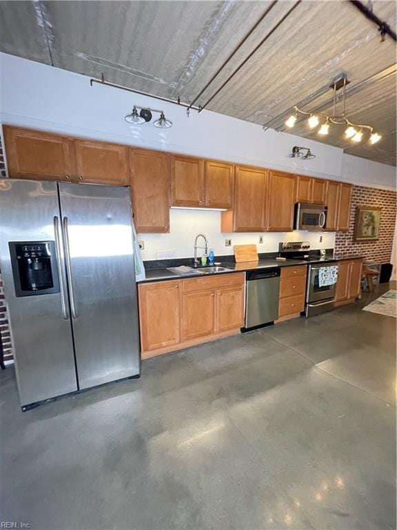 kitchen with sink, decorative light fixtures, and appliances with stainless steel finishes