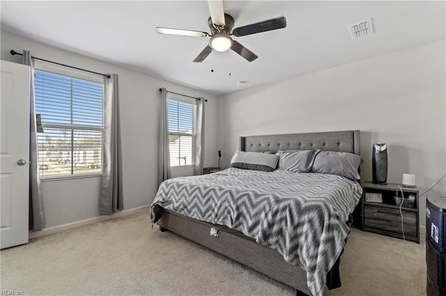 bedroom with ceiling fan and light colored carpet