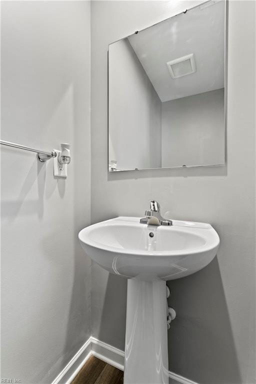 bathroom with wood-type flooring