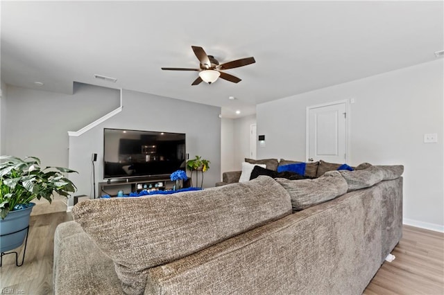 living room featuring ceiling fan and light hardwood / wood-style floors