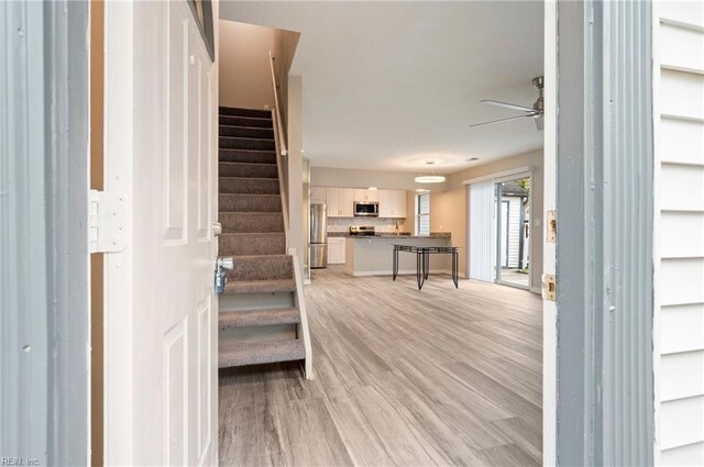 entryway featuring ceiling fan and light hardwood / wood-style floors