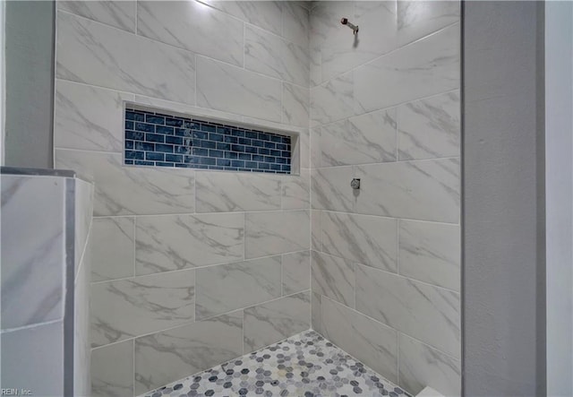 bathroom with tiled shower