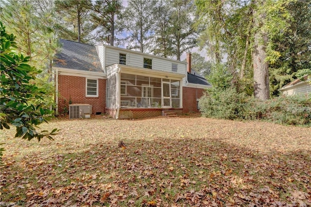 rear view of property with central AC and a sunroom