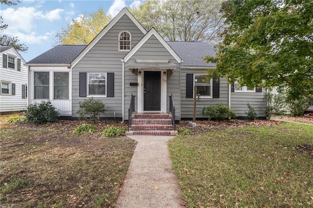 bungalow-style home with a front yard