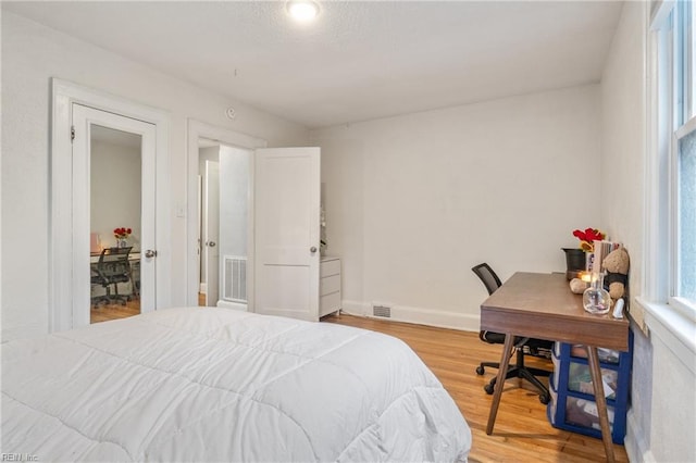 bedroom with hardwood / wood-style flooring