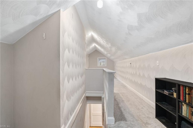 bonus room with carpet flooring and vaulted ceiling