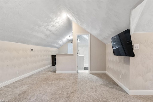 bonus room featuring carpet floors and vaulted ceiling