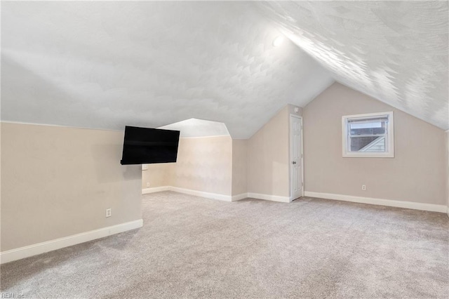 bonus room featuring carpet and vaulted ceiling