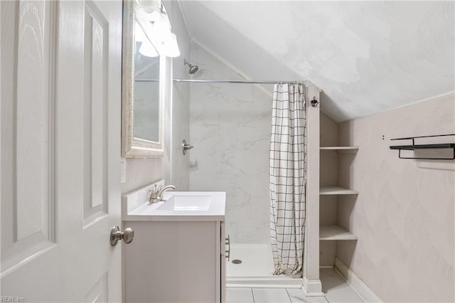 bathroom with curtained shower, tile patterned flooring, vanity, and lofted ceiling