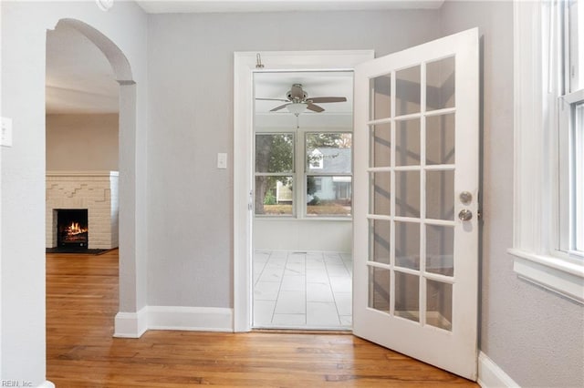 doorway to outside featuring ceiling fan and hardwood / wood-style flooring